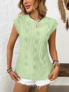 Detail of light green sleeveless knit top with hollow-out diamond pattern and cable texture
