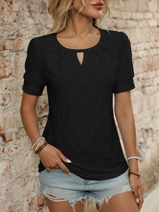 Close-up of black hollow-out knit t-shirt with diamond texture and drop-shaped neckline