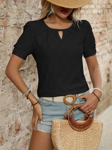 Detail of black short sleeve top featuring teardrop cutout neckline and diamond eyelet texture