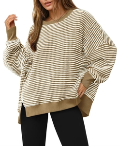Detail view of khaki and white striped knit sweater with ribbed cuffs and split hem