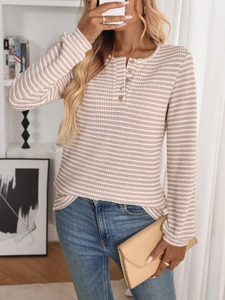Detail of waffle-knit striped long sleeve top featuring classic wooden buttons on neckline