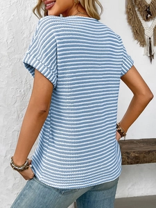 Detail of blue striped V-neck T-shirt showing waffle knit texture and rolled sleeve cuffs