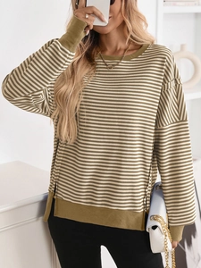 Detail showing army green striped pattern and side slit hem of women sweater