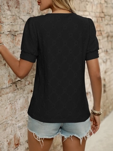 Detail of black hollow-out embroidered T-shirt with diamond pattern back view