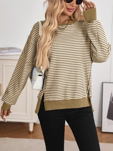 Detailed macro view of olive green striped knit sweater with side slit and ribbed cuffs