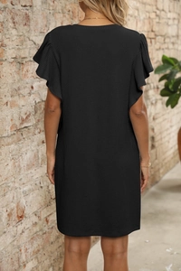 Detail of black V-neck dress with ruffle sleeves and vertical textured fabric on model