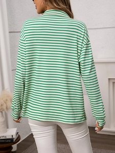 Rear view of a loose-fit green and white striped long sleeve shirt with side slits