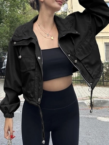 Detail of black cropped windbreaker jacket with cargo pockets and silver metal zipper