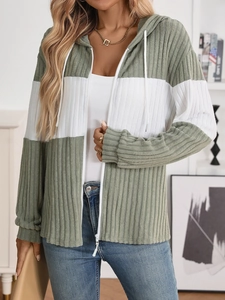Detail of sage green ribbed knit cardigan featuring contrast white zipper and hood drawstring