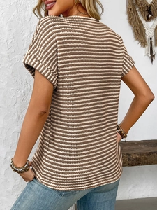 Detail view of brown and white striped waffle knit texture with cuffed short sleeves