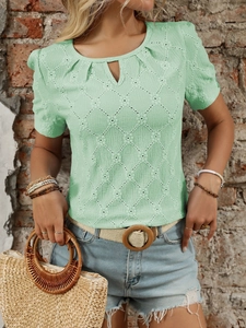 Detail of mint green short sleeve top featuring hollow diamond texture and pleated neckline