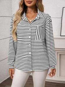 Detail of the black and white striped shirt featuring a vertical striped chest pocket