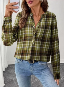 Detailed view of green plaid V-neck shirt with natural buttons and long sleeves