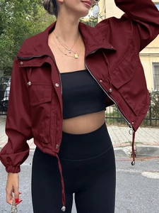 Detail view of wine red short utility jacket with zipper closure and large flap pockets