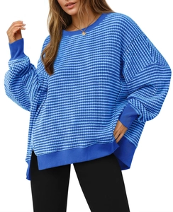 Close-up detail of oversized blue and white striped sweatshirt with side slit design