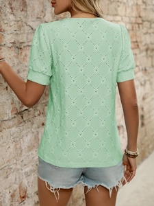 Close-up of mint green t-shirt showing diamond hollow-out texture and soft fabric detail