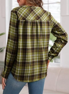 Detail of green and yellow plaid shirt with a back pleat design for a relaxed casual fit