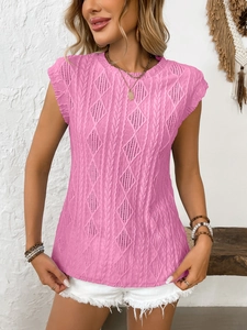 Detail of pink knitted sleeveless top with intricate cable and hollow diamond patterns