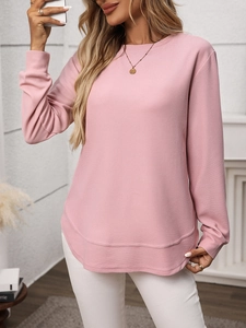 Detailed macro view of pink waffle knit texture and curved hemline on long sleeve tee