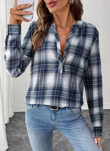 Detail of V-neck plaid blouse with classic blue pattern and rustic wooden buttons