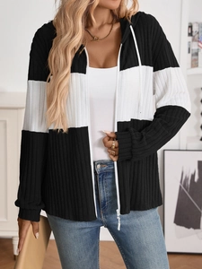 Detail of ribbed knit texture on black and white patchwork hooded cardigan with zipper