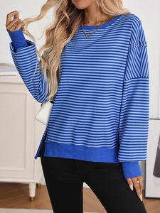 Detail shot of blue striped crewneck knit sweater with side slits and ribbed cuffs