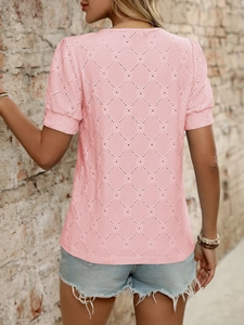Detail view of women's short sleeve top featuring hollow diamond texture and soft pink fabric