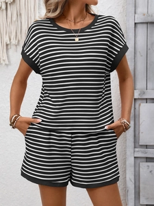 Close-up of black and white striped knit summer set with elastic waistband and pockets