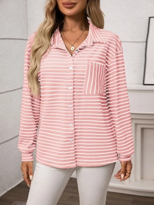 Detail of pink and white striped shirt fabric with buttoned chest pocket and classic collar