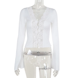 Detail of white long sleeve top with floral lace trim and elegant pearl buttons