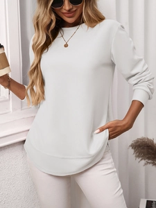 Detail view of white waffle knit long sleeve shirt with curved hem and side pockets