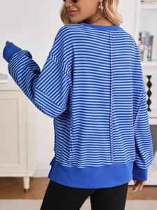Detail of blue striped sweatshirt showing back seam stitching and ribbed hem texture