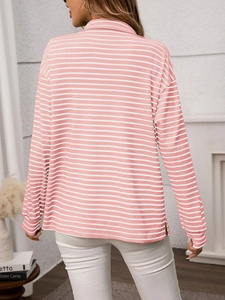 Detail view of pink striped top with side slit hem and loose drop shoulder design