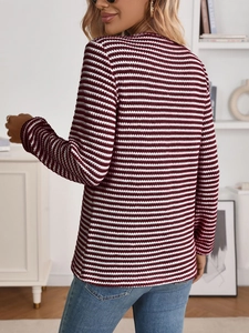 Close-up of wine red and white striped knit texture and back stitching of the long-sleeve tee