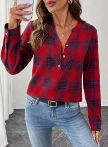 Detail of red and blue plaid shirt featuring a small V-neckline with three front buttons