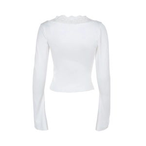 Detailed view of white long-sleeve top with delicate lace trim on the V-neckline