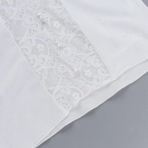 Detail of elegant white lace panel with pearl buttons on woman's fashion v-neck top