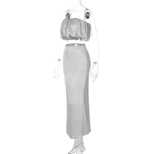 Detailed macro view of glossy silver satin off-shoulder crop top and high waist skirt set