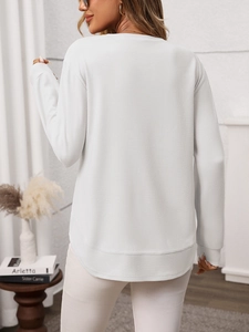 Back view of a white waffle knit long sleeve shirt with a curved hem and drop shoulders
