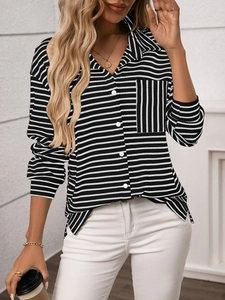 Detail of loose black and white striped shirt with a vertical stripe chest pocket and buttons