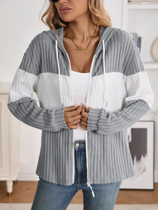 Close-up of women's rib-knit zip-up hoodie featuring grey and white patchwork details
