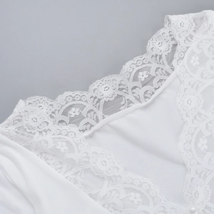 Close-up of the delicate white lace trim and V-neckline texture on the casual women's top