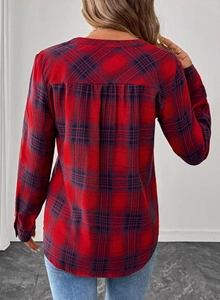 Detail of classic red and blue plaid shirt back featuring center pleat and curved hemline