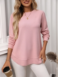 Close-up of pink waffle knit texture and curved hem on women long sleeve casual t-shirt