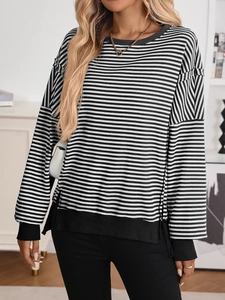 Detail of loose-fit striped sweatshirt with dropped shoulders and ribbed cuffs