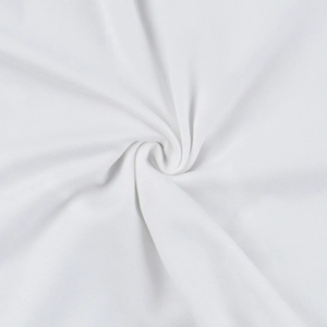 Detail shot of soft white knit fabric with delicate lace texture and elegant spiral drape