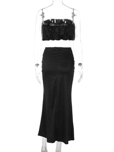 Rear view of two-piece black strapless crop top and slim maxi skirt with back zipper