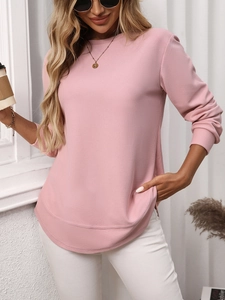 Close-up of pink waffle knit fabric texture on a long sleeve crewneck casual top