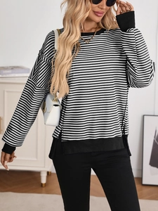 Detail of striped knit sweater showing crew neck design and soft textured fabric finish