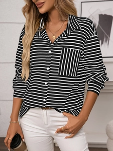 Detail of the black and white striped shirt showing the V-neck and vertical striped pocket